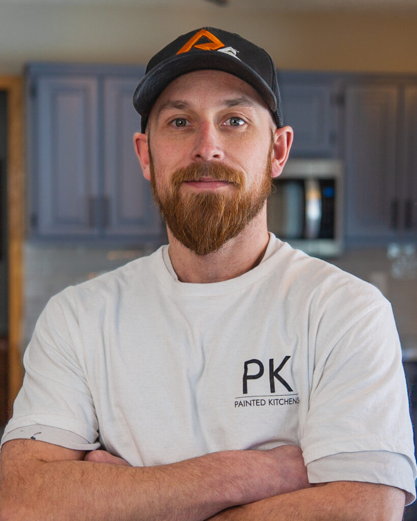 Drew, founder of Painted Kitchens, standing in a client’s kitchen